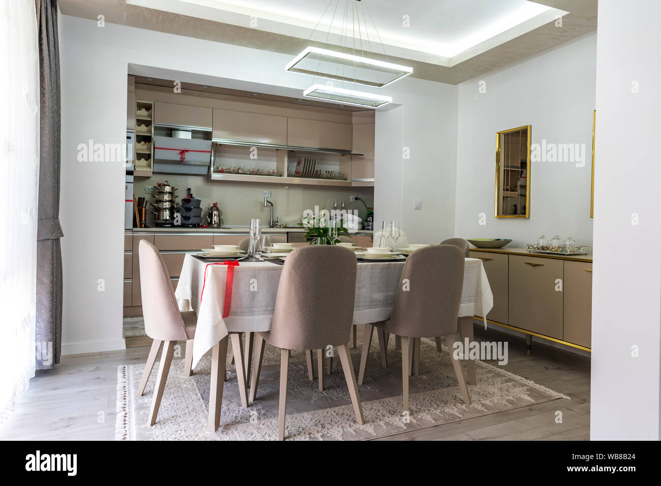 Modern gray kitchen with table set Stock Photo - Alamy