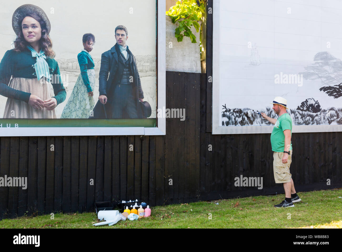 Bournemouth, Dorset UK. 25th August 2019. British artist David Downes has been commissioned by ITV to create a large scale mural to launch their new drama Sanditon, based on the unfinished novel by Jane Austen. The mural of the fictional town of Sanditon will be 12 metres wide and is being painted over 5 days starting today ahead of the first episode of Sanditon on TV this evening; the mural will then be on display for 3 weeks. Credit: Carolyn Jenkins/Alamy Live News Stock Photo