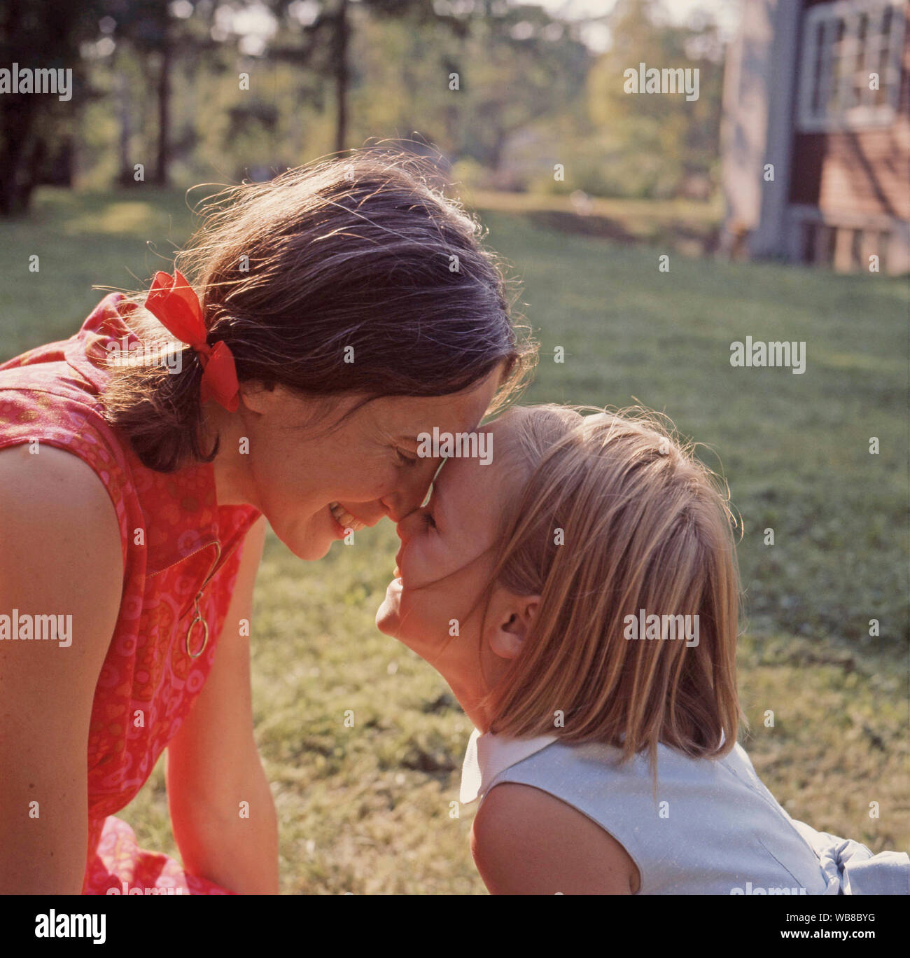1960s parent. A mother and her daughter play together outside. Sweden 1969 Stock Photo