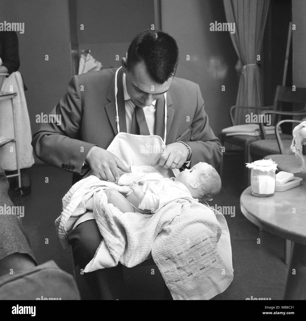 Learning to have a baby in the 1960s. A class in how to take care of a baby. A class that men and women go when they are about to be parents for the first time.  March 1963. Sweden Stock Photo