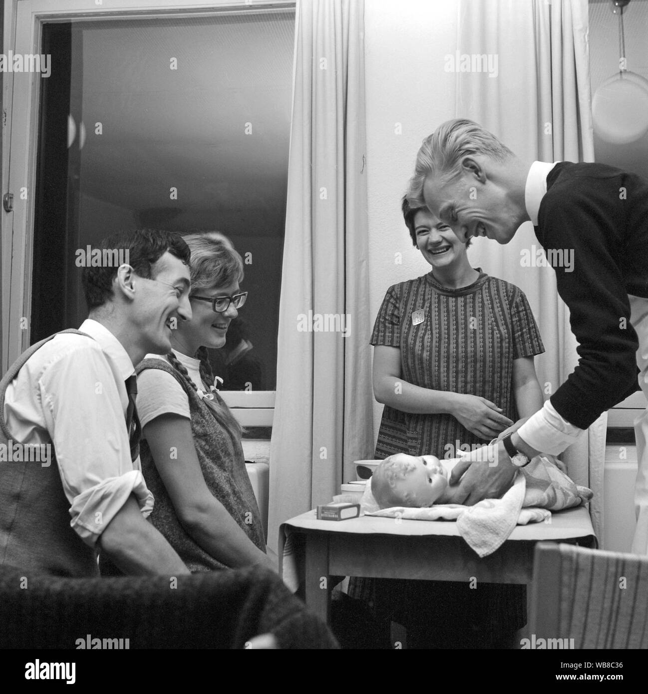 Learning to have a baby in the 1960s. A class in how to take care of a baby. A class that men and women go when they are about to be parents for the first time.  March 1963. Sweden Stock Photo