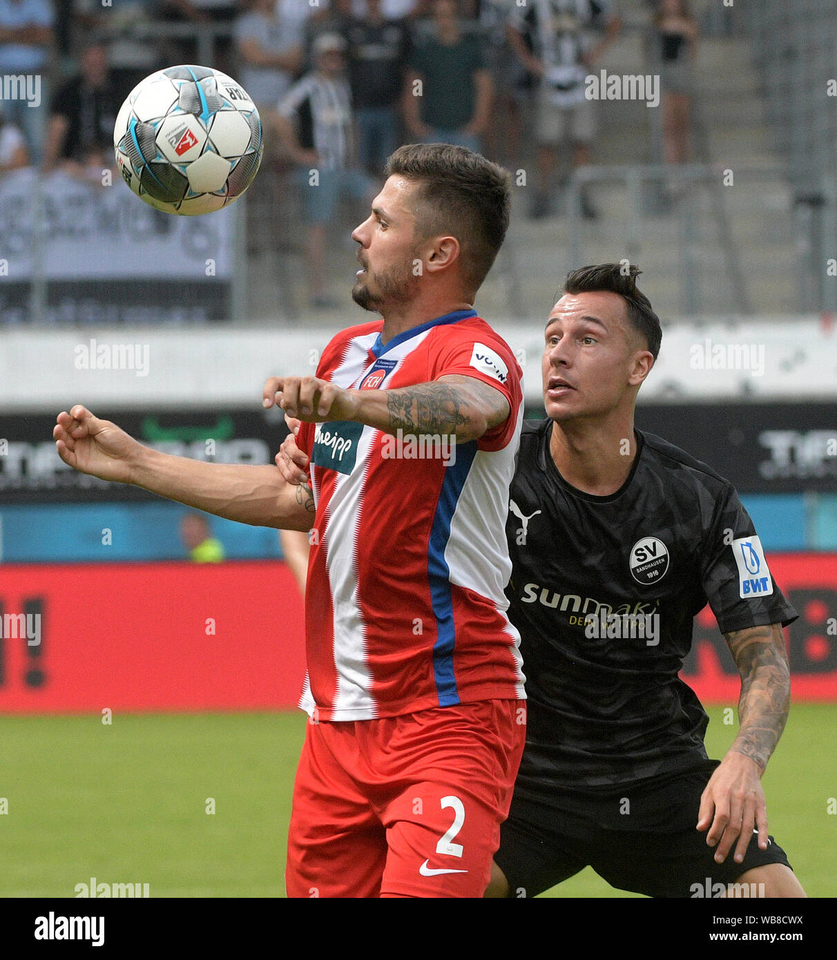 Heidenheim, Germany. 25th Aug, 2019. Soccer: 2nd Bundesliga, 1st FC Heidenheim - SV Sandhausen, 4th matchday in the Voith Arena. Heidenheim's Marnon Busch (l) and Mario Engels von Sandhausen fight for the ball. Credit: Stefan Puchner/dpa - IMPORTANT NOTE: In accordance with the requirements of the DFL Deutsche Fußball Liga or the DFB Deutscher Fußball-Bund, it is prohibited to use or have used photographs taken in the stadium and/or the match in the form of sequence images and/or video-like photo sequences./dpa/Alamy Live News Stock Photo