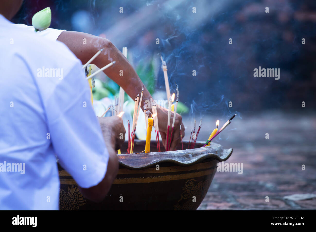 Burning incense and candles at thai buddhis celebration - Visakha Bucha Day Stock Photo