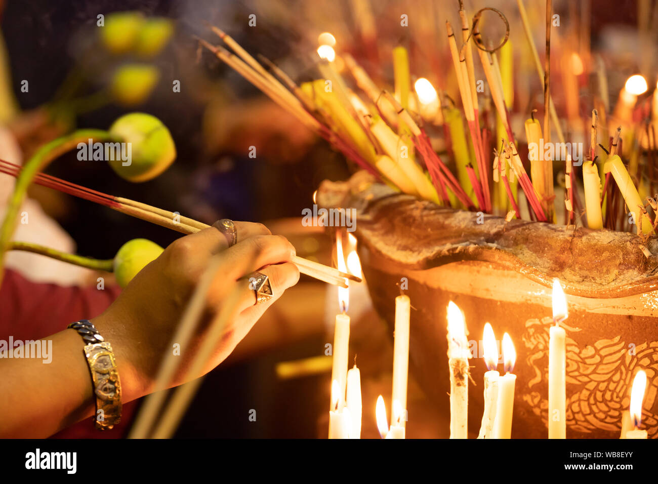 Burning incense and candles at thai buddhis celebration - Visakha Bucha Day Stock Photo