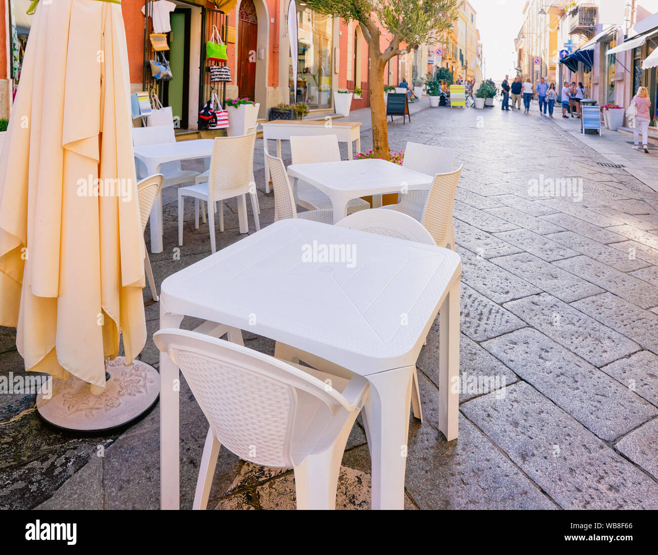 Restaurant tables and people on Corso Umberto I Street in Old city of ...