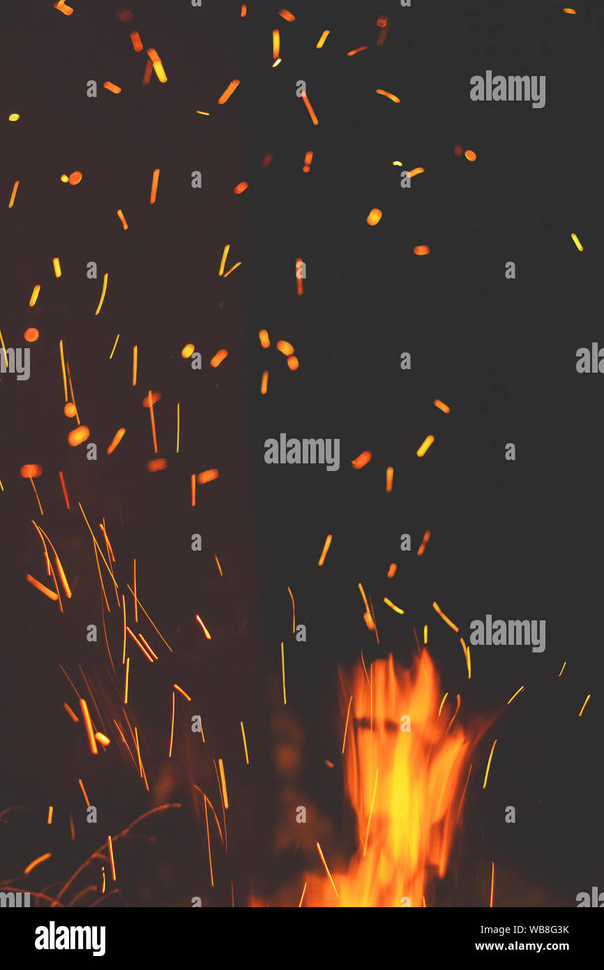 Night bonfire with sparks in motion blur. Toned photo Stock Photo - Alamy