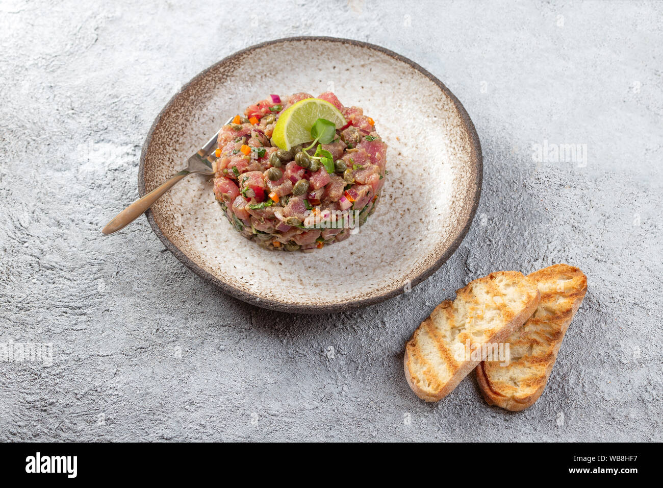 Tuna fish TARTAR tartare on gray plate Stock Photo Alamy