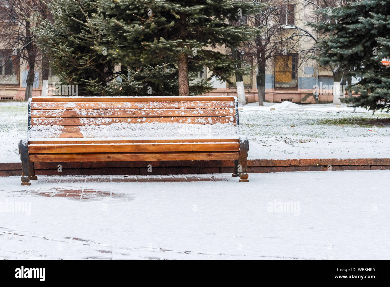 Empty bench in a snow-covered park in winter Stock Photo - Alamy