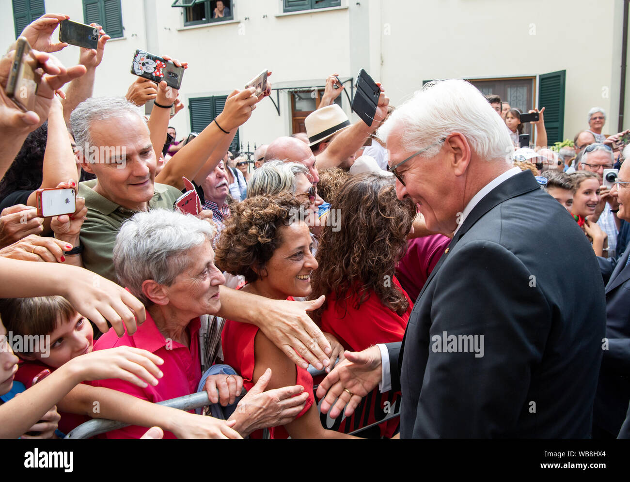 Fivizzano, Italy. 25th August 2019. Federal President Frank-Walter Steinmeier greets visitors at a commemorative event for the victims of the massacres at Fivizzano. In the final phase of the Second World War, Wehrmacht soldiers and SS murdered several thousand civilians in Italy. 75 years ago, in the region around Fivizzano in northern Tuscany alone, almost 400 men, women, old people and children were murdered by the Germans, often in an unimaginably cruel way, in a massacre lasting several days. Federal President Steinmeier and his wife take part in the annual commemoration ceremony for the  Stock Photo