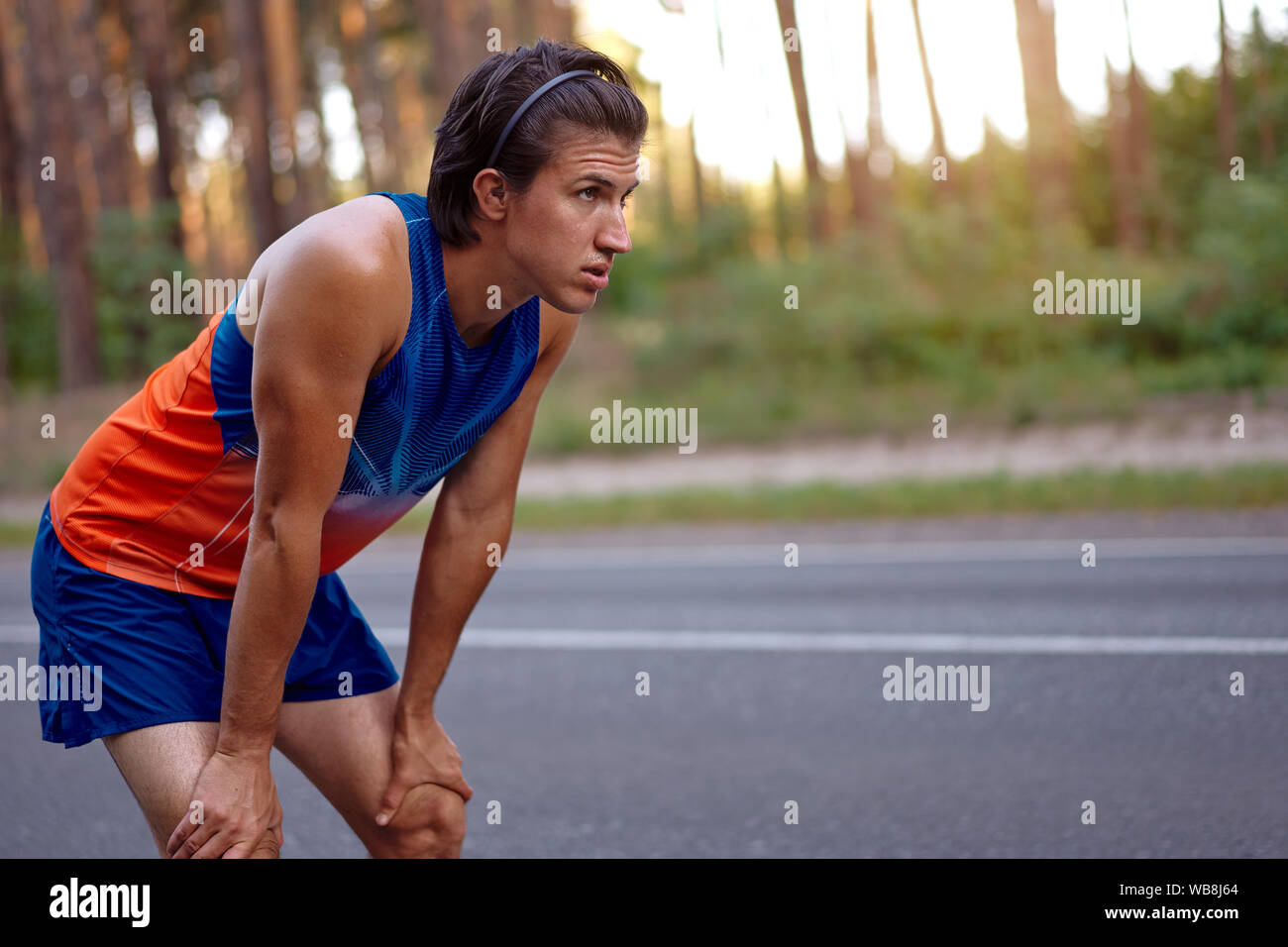 Runner man resting after running training for triathlon. Male fitness