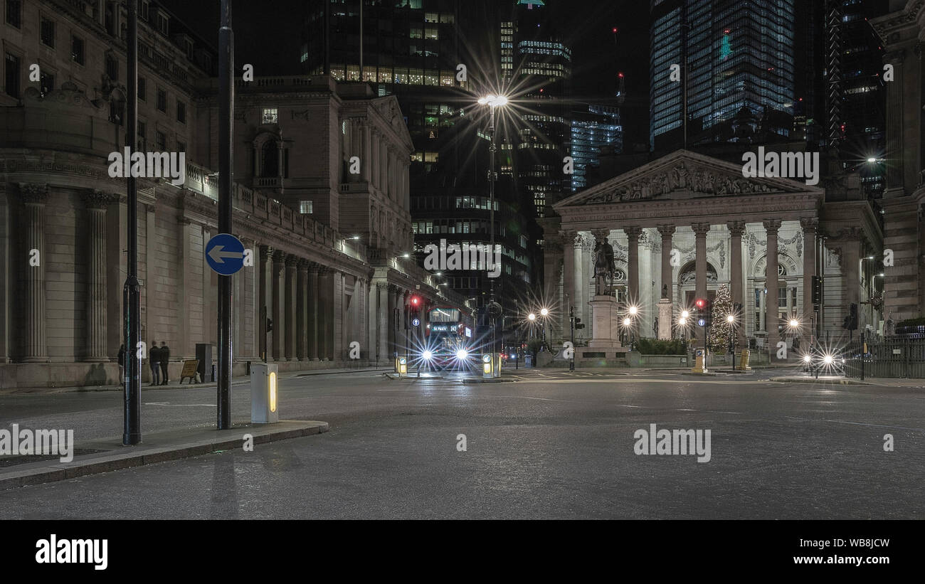 London streets at night near Bank of England building with passing transport Stock Photo