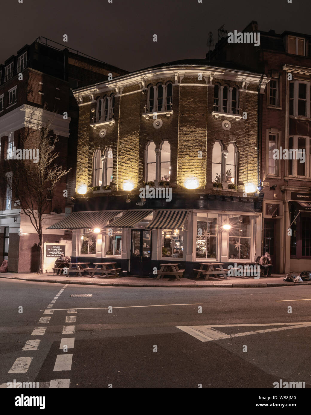 London pub at night. passing cab. London streets Stock Photo