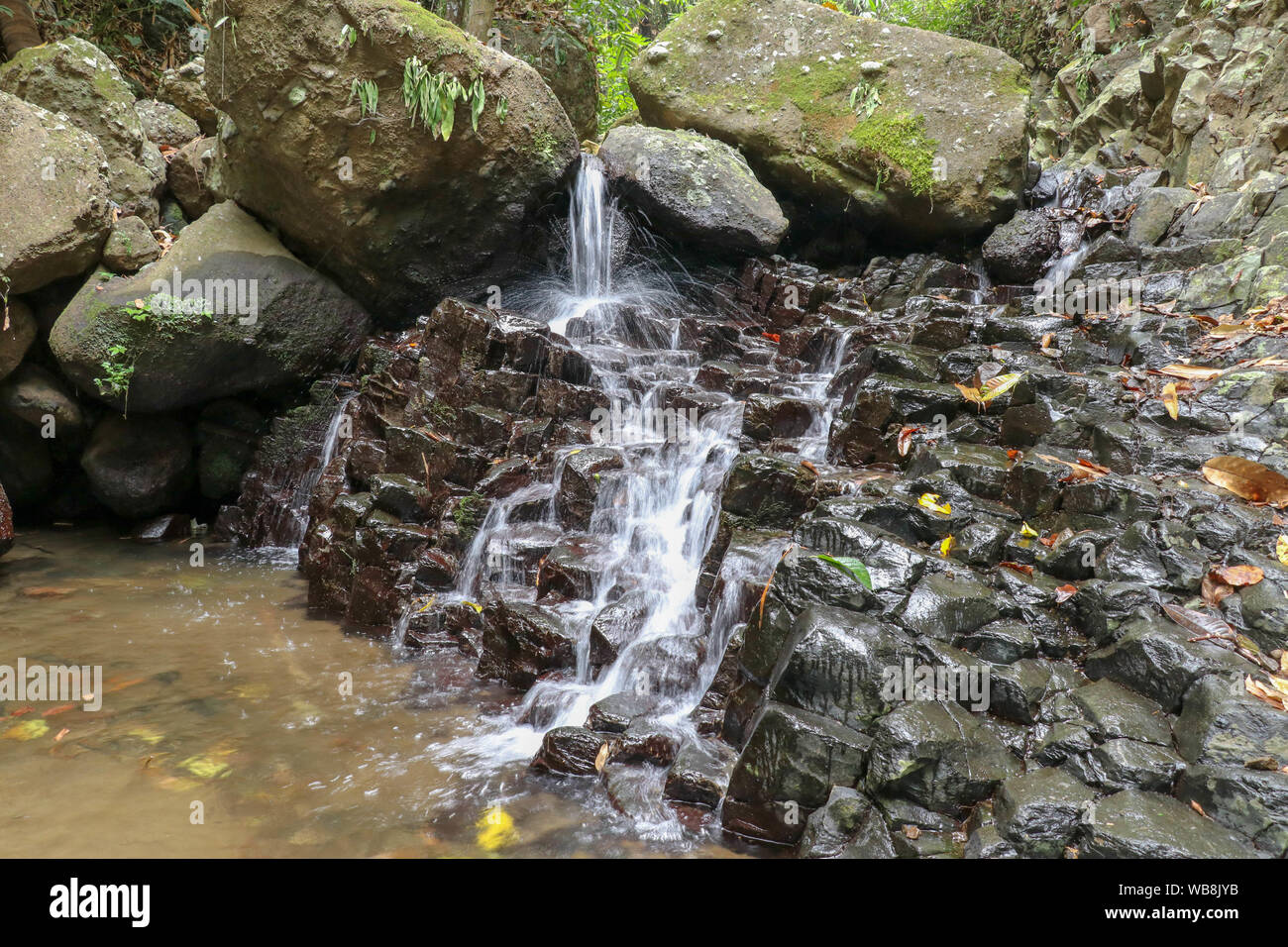 Small river flows down rocky hi-res stock photography and images - Alamy