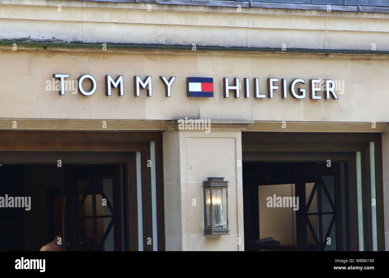 Tommy Hilfiger store and it's famous logo in a prime posiition along  Brompton Road amongst the Luxury brands in London's prestige shopping area  in Knightsbridge Stock Photo - Alamy