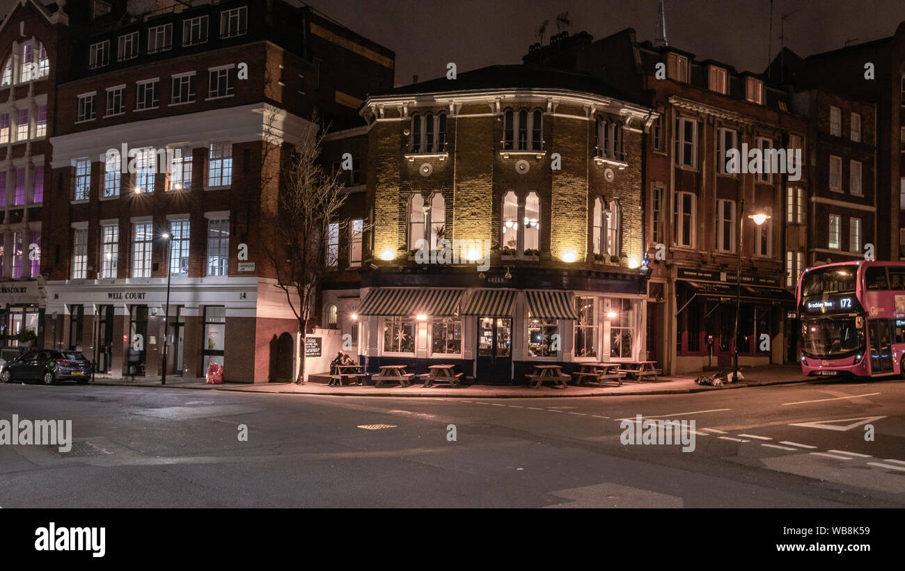 London pub at night. passing cab. London streets Stock Photo