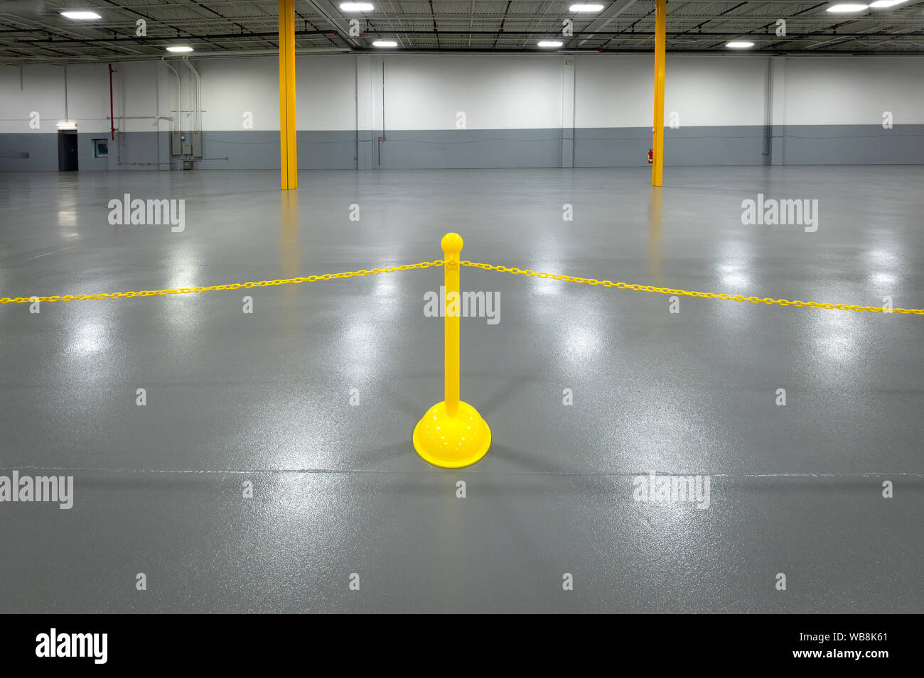 Yellow plastic stanchion in warehouse Stock Photo