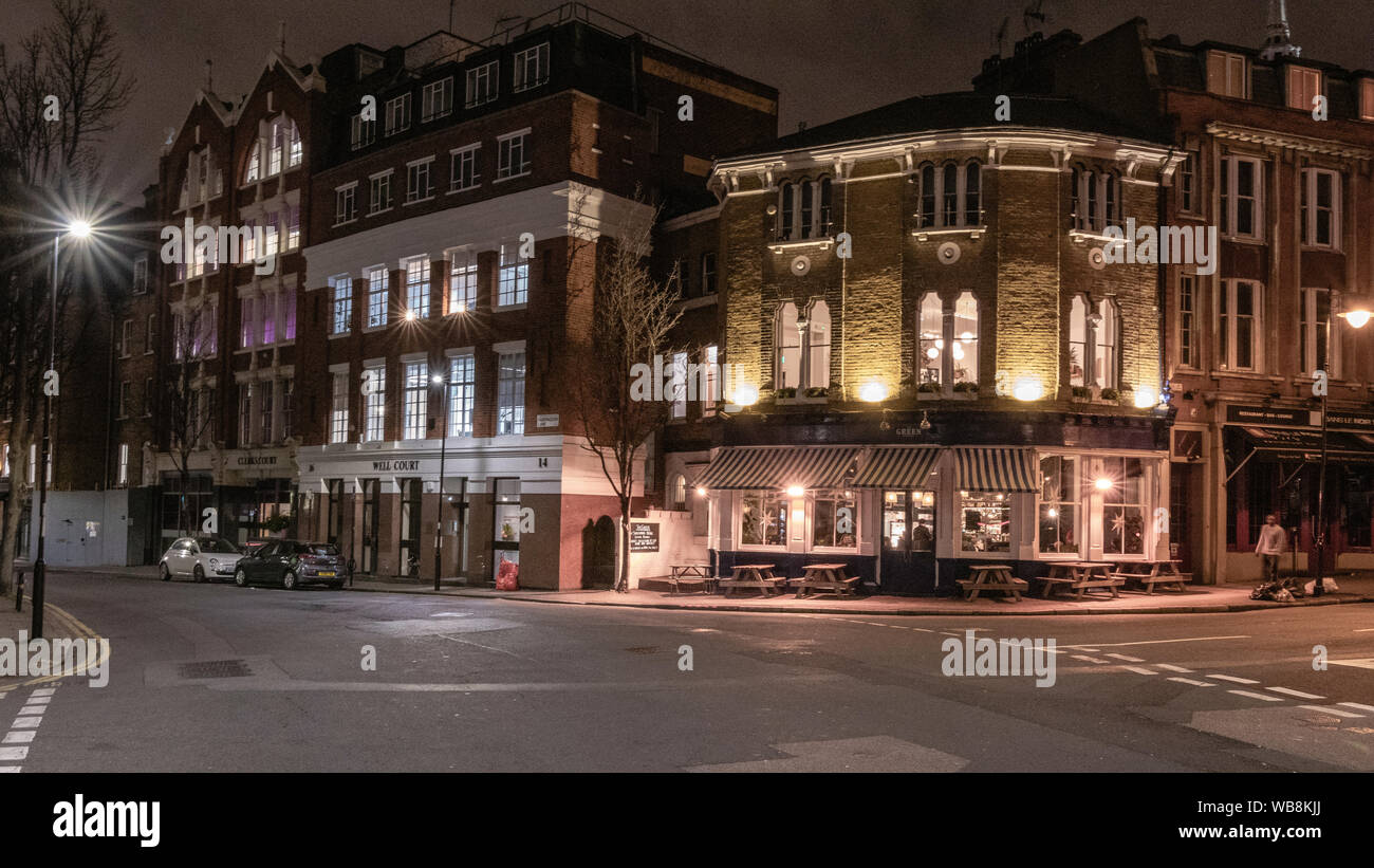 London pub at night. passing cab. London streets Stock Photo