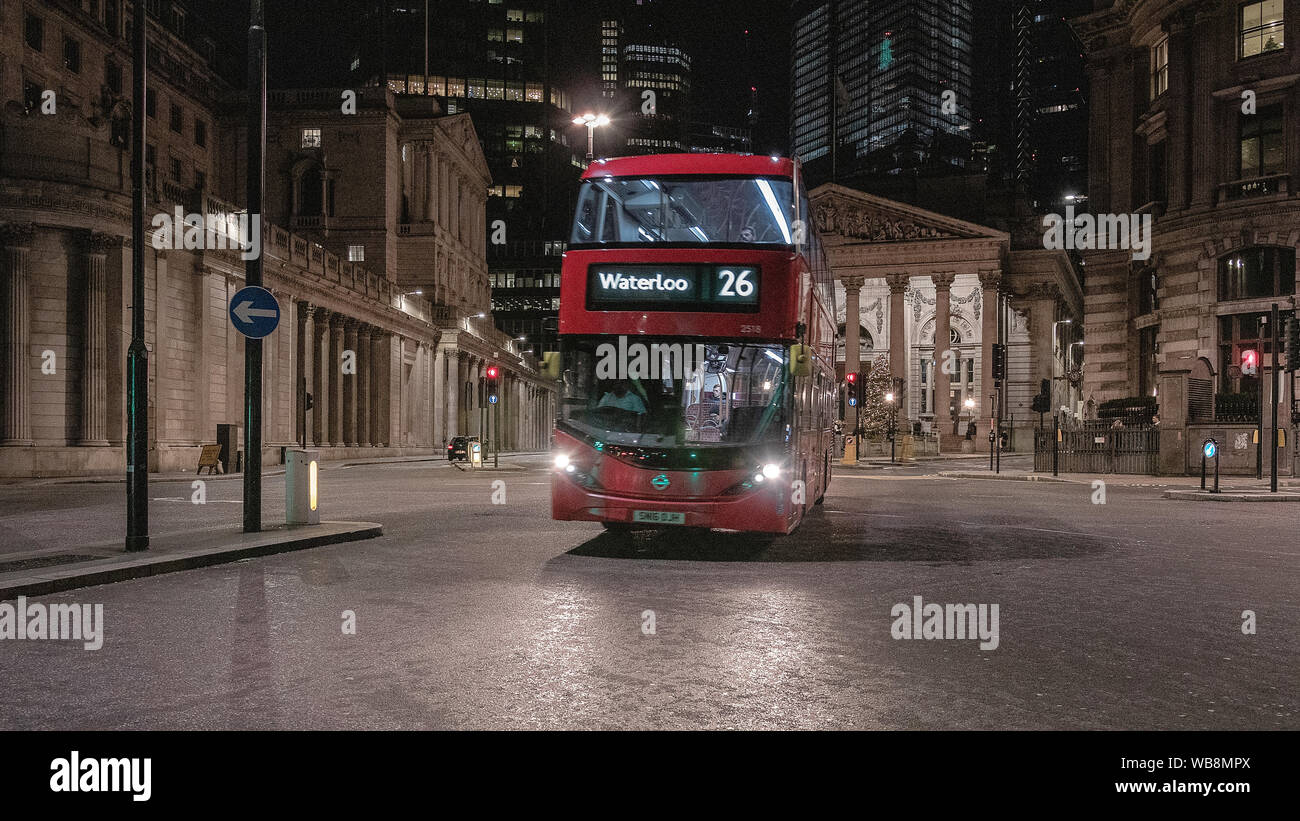London streets at night near Bank of England building with passing transport Stock Photo