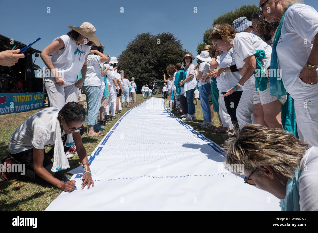 Jerusalem, Israel. 25th August, 2019. Women Wage Peace kick start their 4 day 'Journey of Hope' with an event at the Wohl Rose Garden opposite the Knesset ahead of the second round of 2019 national elections scheduled for 19th September, 2019. Assembling from all over the country, both Jewish and Arab women, they voice their demand from government for a political agreement with the country's adversaries and urge everyone to vote without concessions on equality, security and peace. Credit: Nir Alon/Alamy Live News. Stock Photo