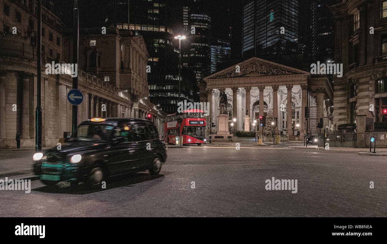 London streets at night near Bank of England building with passing transport Stock Photo