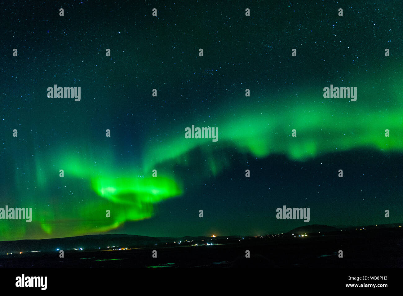 Strong activity of northern lights in Iceland with characteristic vivid green glow and strange movement delivering an abstract pattern, april 2018 Stock Photo