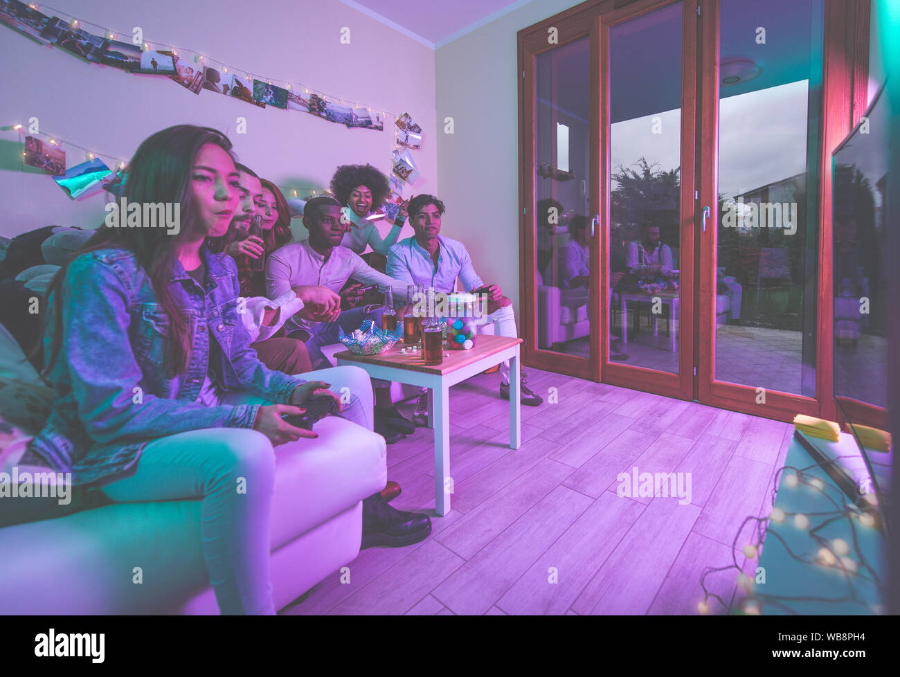 A Group Of Young People Celebrating And Making Party At Home Stock