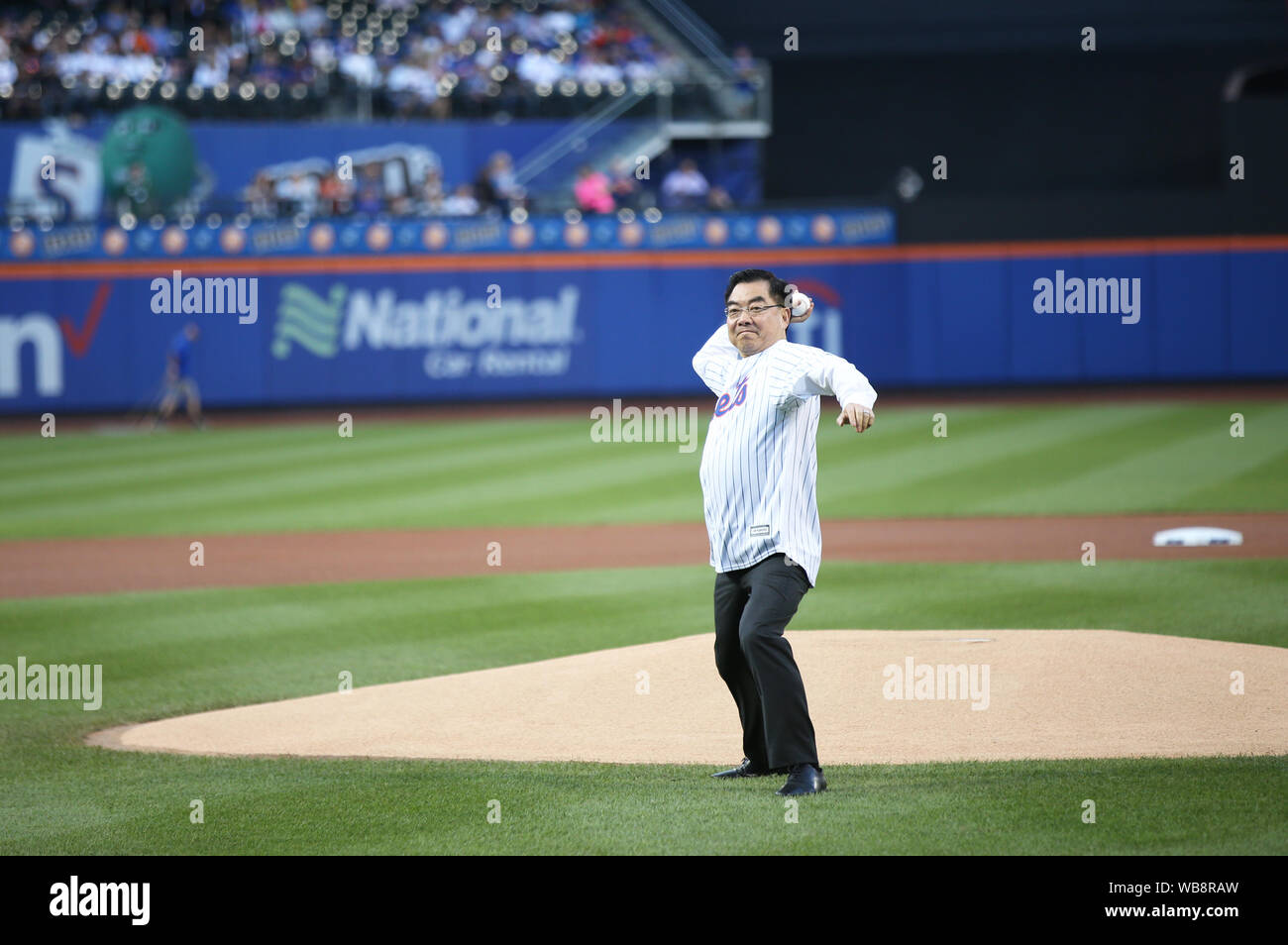 New York, USA. 24th Aug, 2019. Huang Ping, Chinese Consul General in New York, throws a ceremonial first pitch to start an MLB game between the Mets and the Atlanta Braves in Citi Field, New York, the United States, Aug. 24, 2019. The 12th annual event "An Evening of Chinese Culture" was held on Saturday evening in New York's Citi Field, an iconic stadium serving as the home field for the New York Mets. Credit: Qin Lang/Xinhua/Alamy Live News Stock Photo