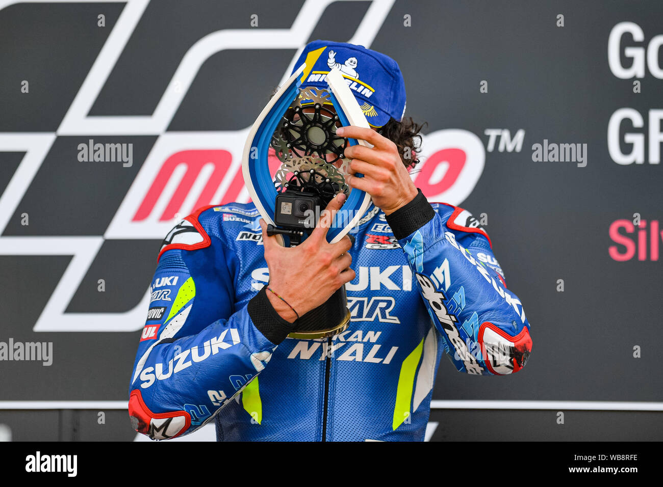 Towcester, UK. 25th Aug, 2019. Alex Rins (SPA) of Team SUZUKI ECSTAR celebrates winning the Sunday Race at presentation after the Sunday’s Race of  GoPro British Grand Prix at Silverstone Circuit on Sunday, August 25, 2019 in TOWCESTER, ENGLAND. Credit: Taka G Wu/Alamy Live News Stock Photo