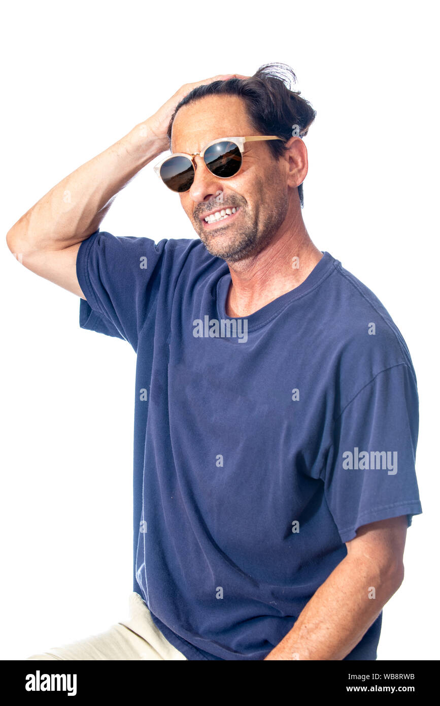 Healthy, masculine, and happy middle aged man smileing while feeling handsome wearing reflective aviator sunglasses in high key background. Stock Photo