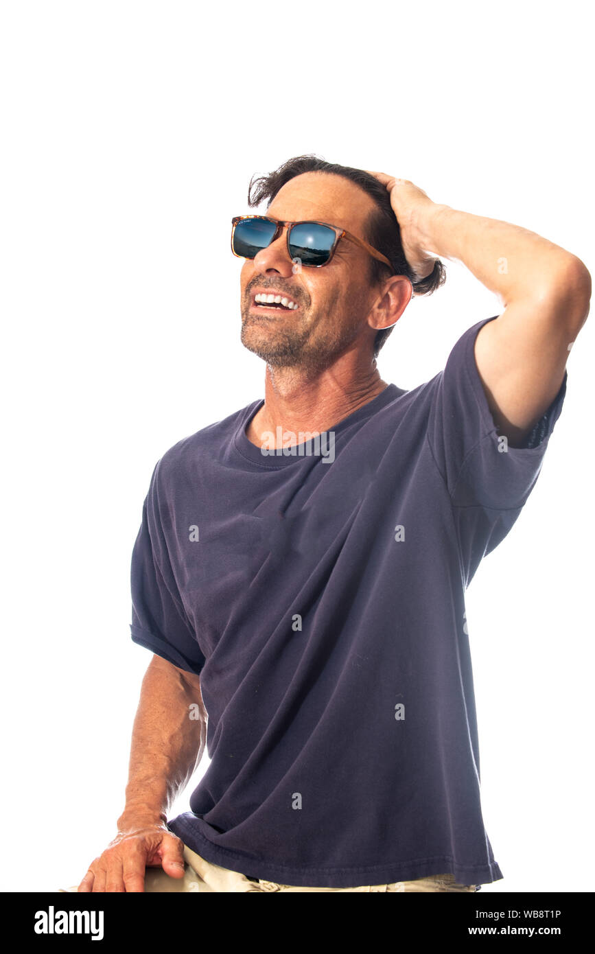 Healthy, masculine, and happy middle aged man smileing while feeling handsome wearing reflective sunglasses in high key background. Stock Photo