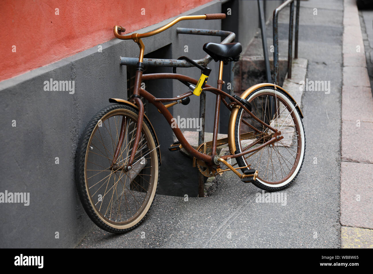 Retro styled bike locked to a railing Stock Photo