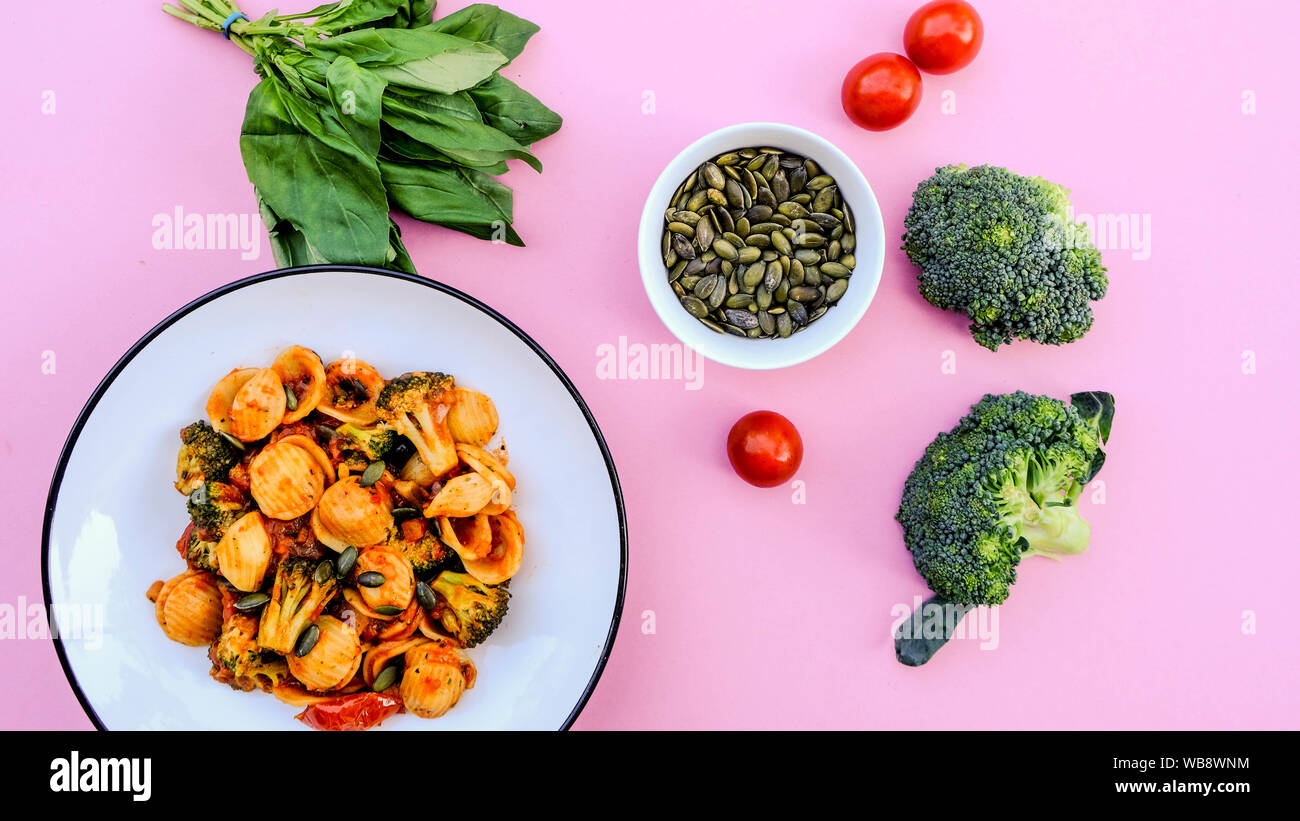 Italian Style Broccoli Orecchiette Pasta Vegetarian Meal With Sundried Tomatoes and Black Olives Stock Photo
