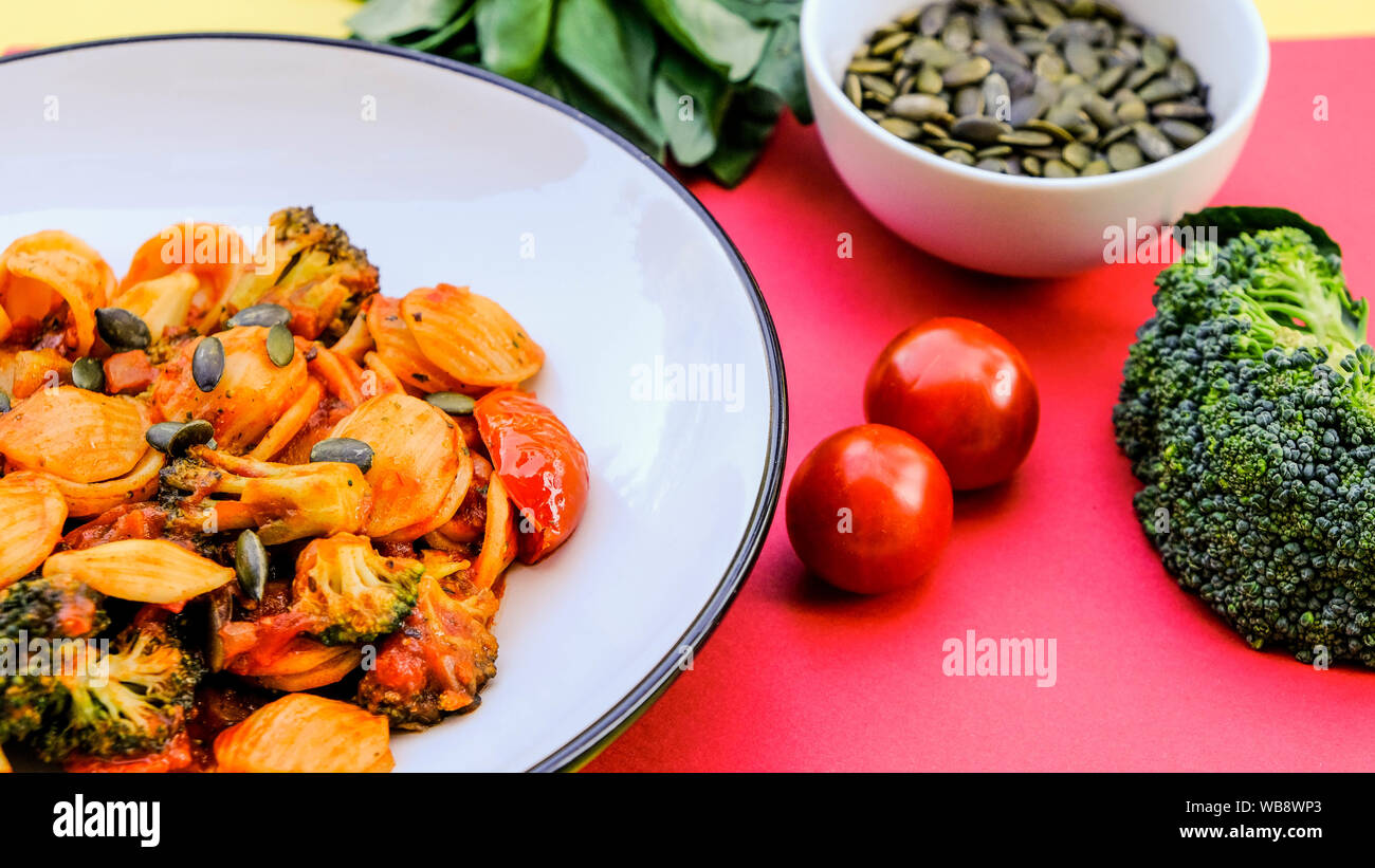 Italian Style Broccoli Orecchiette Pasta Vegetarian Meal With Sundried Tomatoes and Black Olives Stock Photo