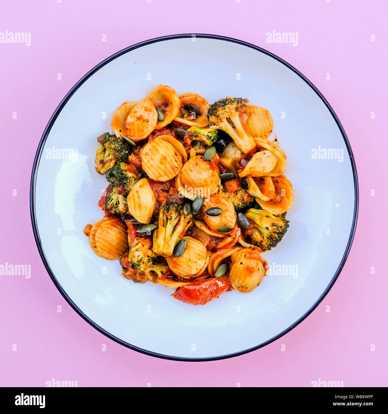 Italian Style Broccoli Orecchiette Pasta Vegetarian Meal With Sundried Tomatoes and Black Olives Stock Photo