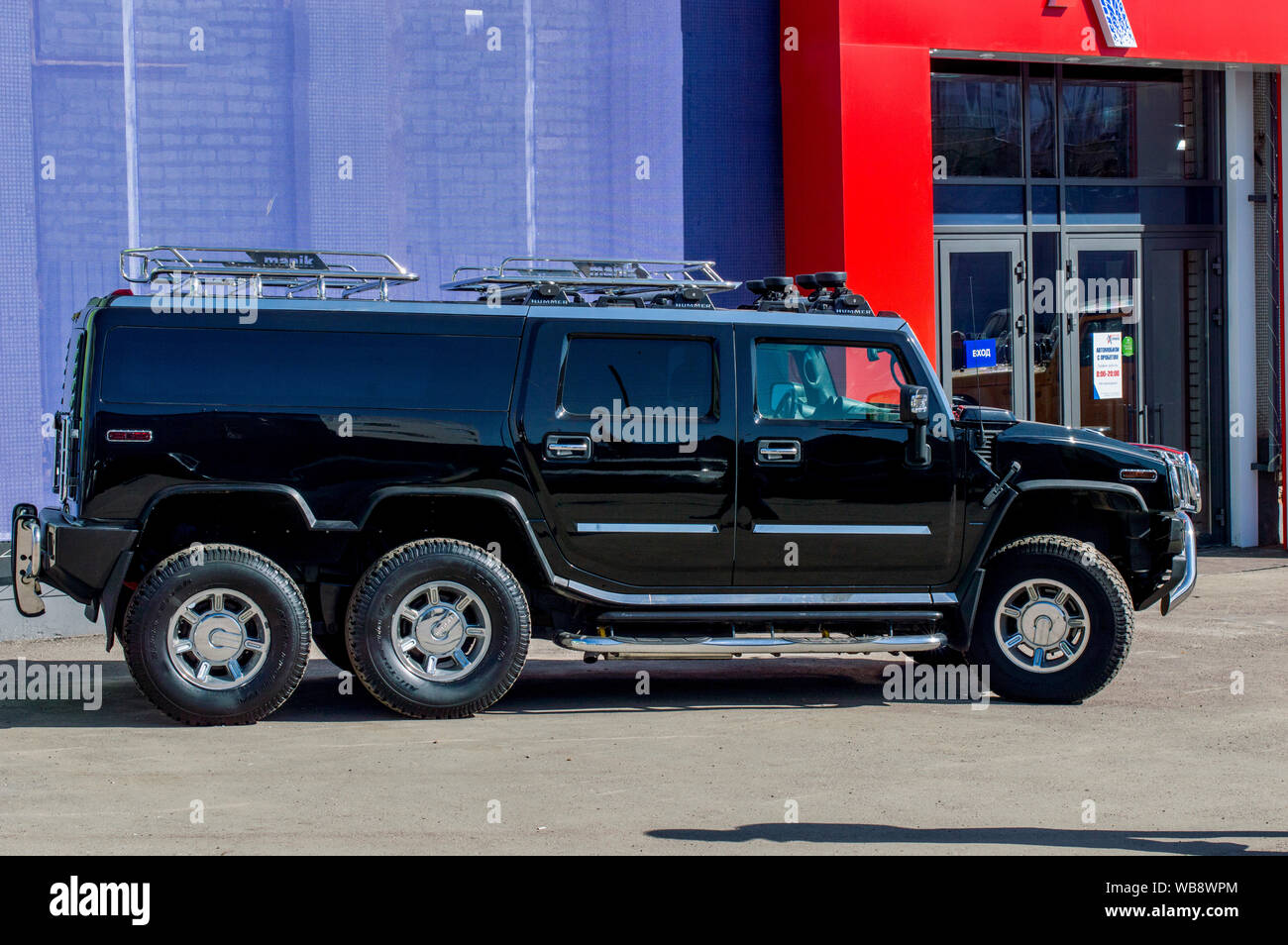 Firm 'Nizhegorodets.' A three-axle, black, chrome-plated Hummer car, stands near the salon. Russia Stock Photo