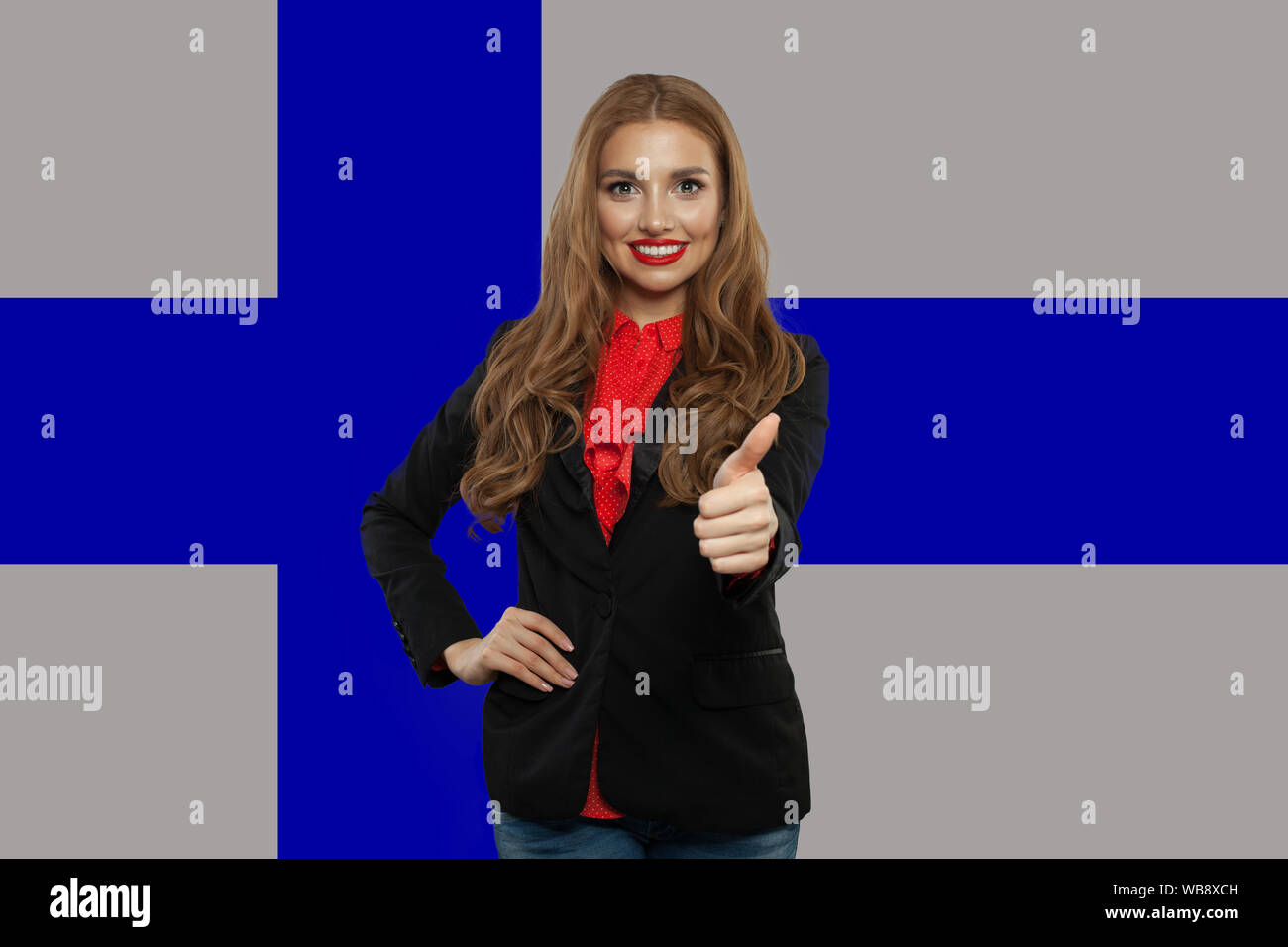 Finland. Young happy woman with thumb up against the Finnish flag background Stock Photo