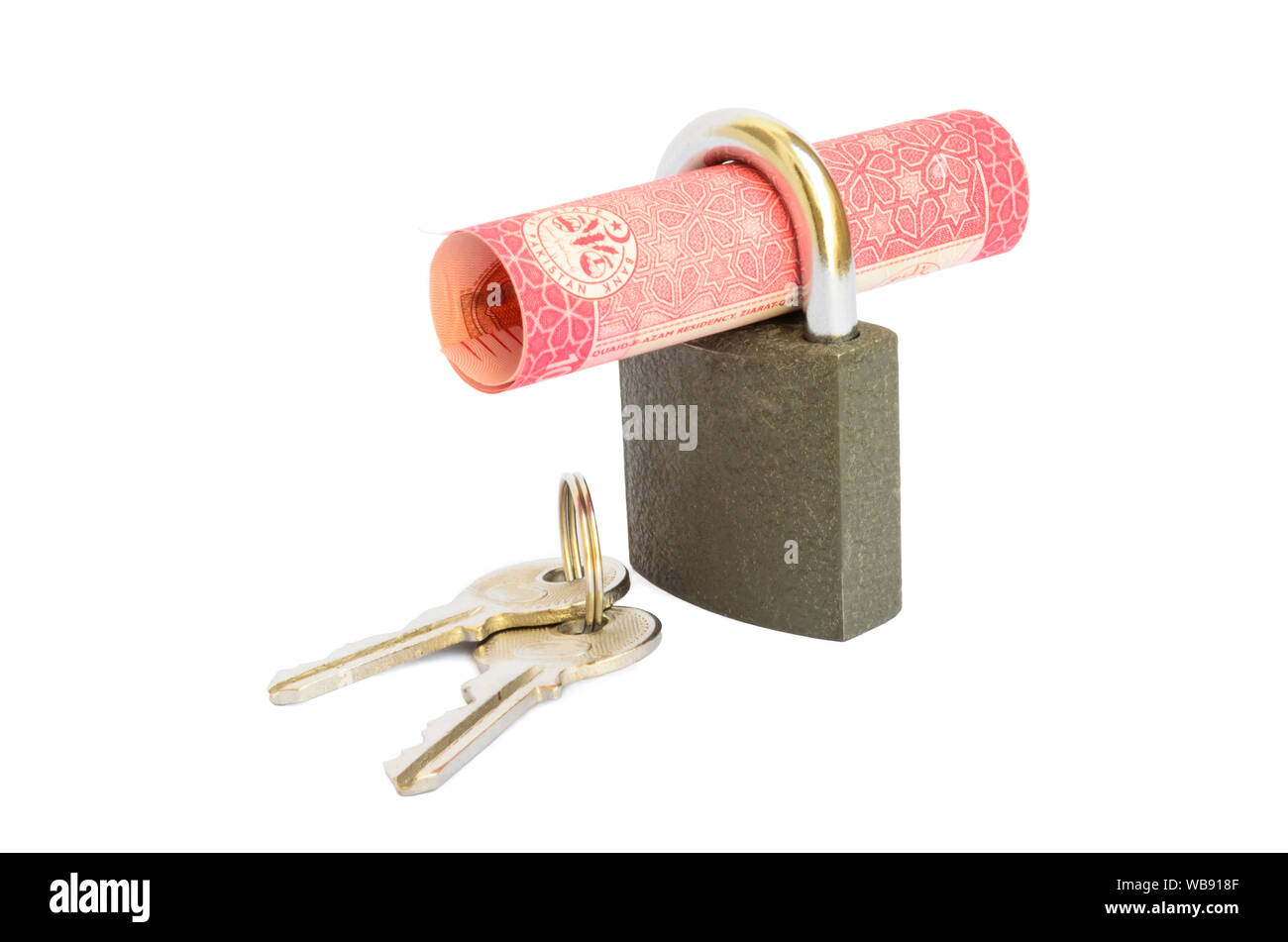 Hundred rupee Pakistani currency note rolled in a padlock Stock Photo