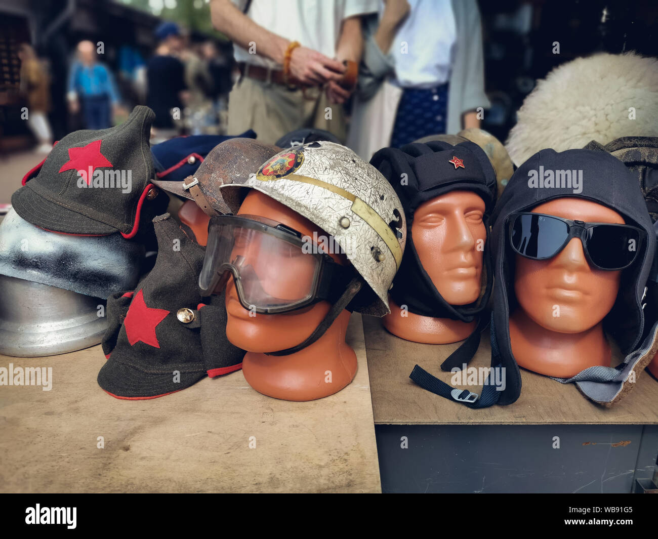 Saint-Petersburg, Russia - 22 July 2019: aviation helmets and cap Soviet times revolution and sunglasses on a mannequin, at the Flea market. Stock Photo
