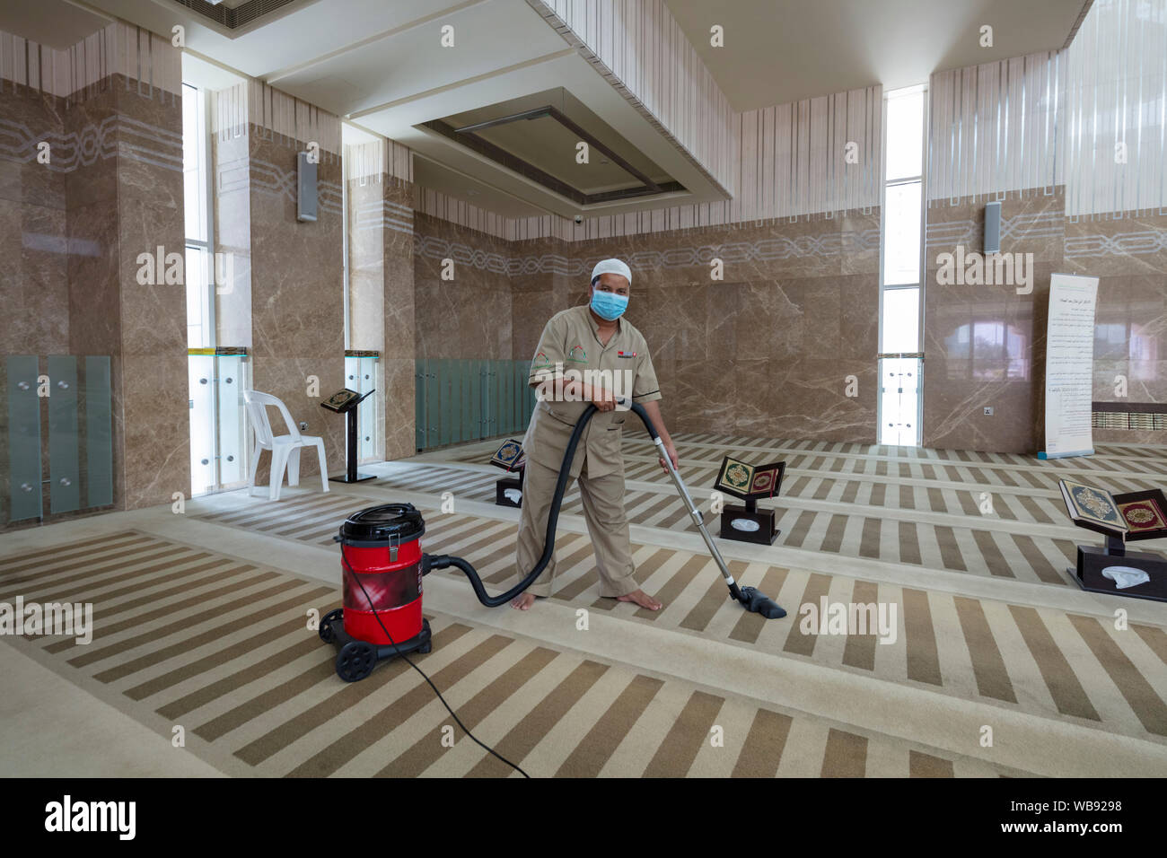 worker vacuuming interior, al-Aziz mosque, Abu Dhabi, United Arab Emirates Stock Photo