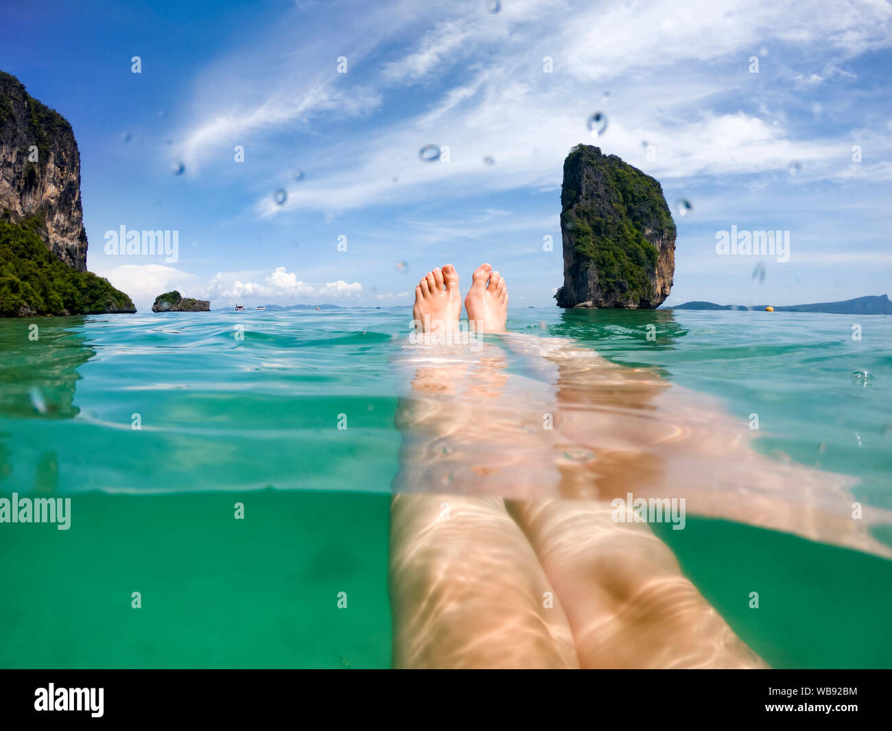 Legs Of Woman In Crystal Clear Sea Water Krabi Thailand Summer