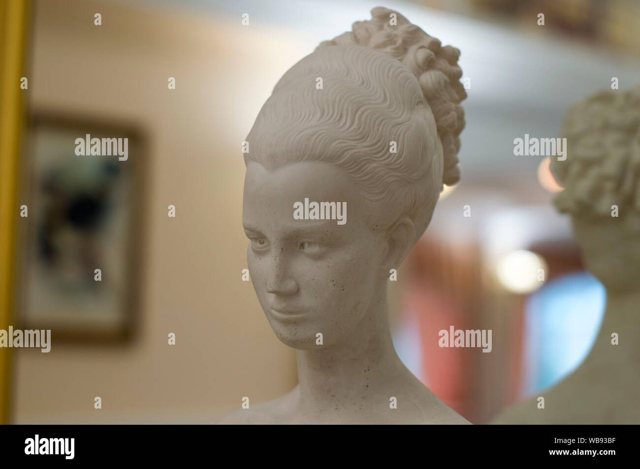 NIZHNY NOVGOROD, RUSSIA October 30, 2016:  The head of a young girl, made of gypsum, on a shelf, near the mirror. Stock Photo