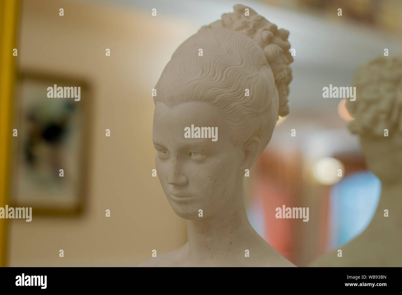 NIZHNY NOVGOROD, RUSSIA October 30, 2016:  The head of a young girl, made of gypsum, on a shelf, near the mirror. Stock Photo