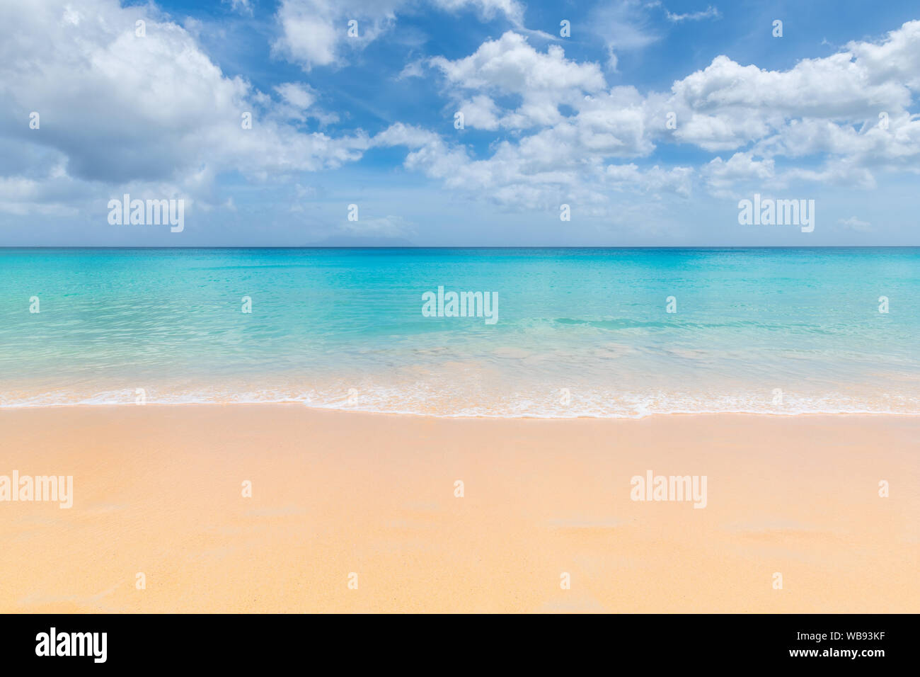 Beautiful clean sandy beach with soft blue ocean wave. Stock Photo