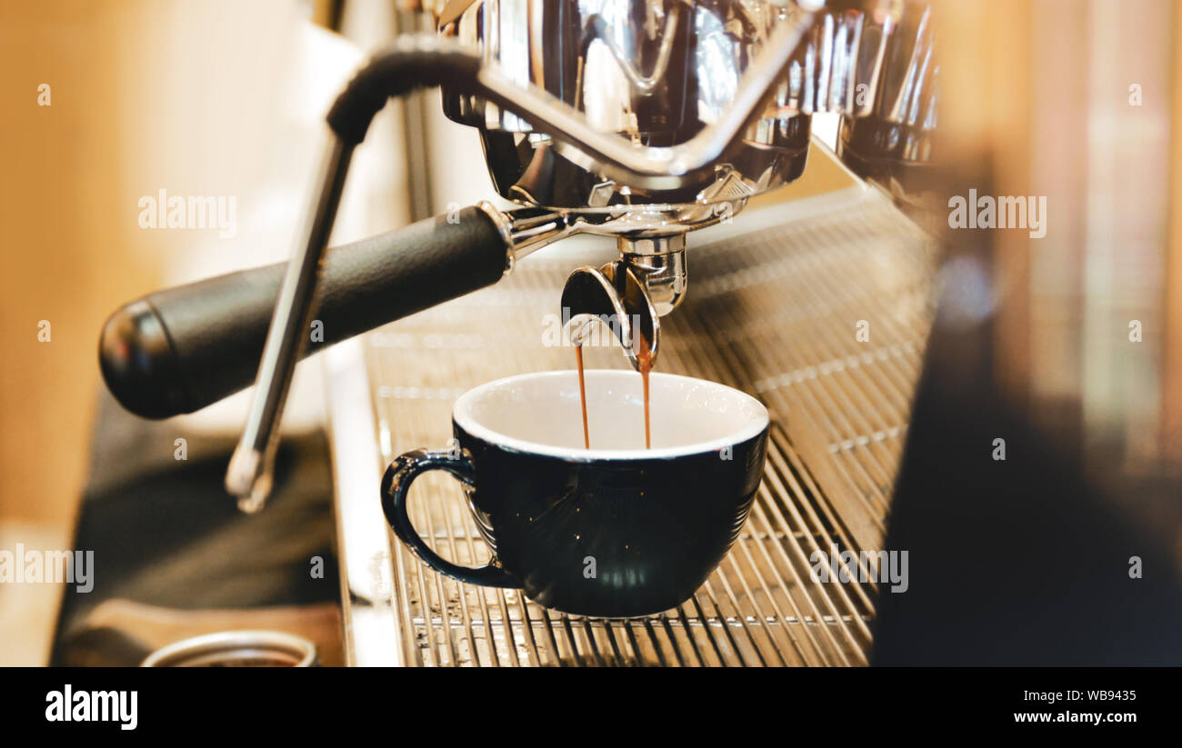 Close-up of espresso machine and shot glasses during a pour Stock Photo -  Alamy