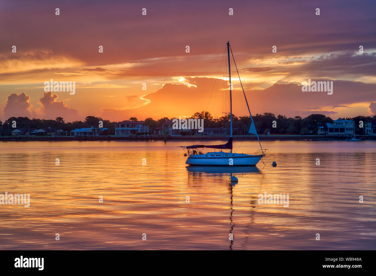 Sailboat at sunrise Stock Photo - Alamy