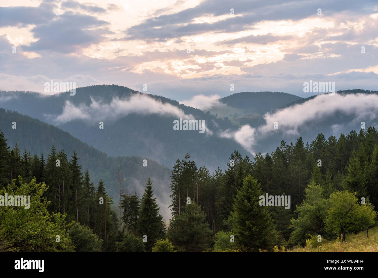 Amazing mountain landscape with colorful vivid sunset at fog Stock ...