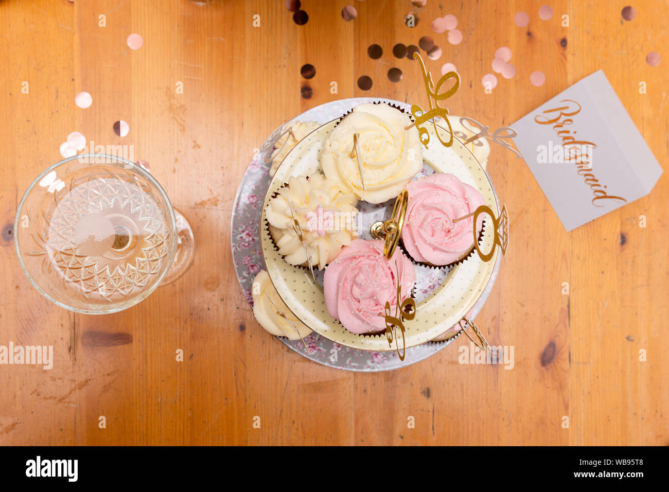 Wedding party cupcakes and glass of champagne on wooden table. Bachelorette party Stock Photo
