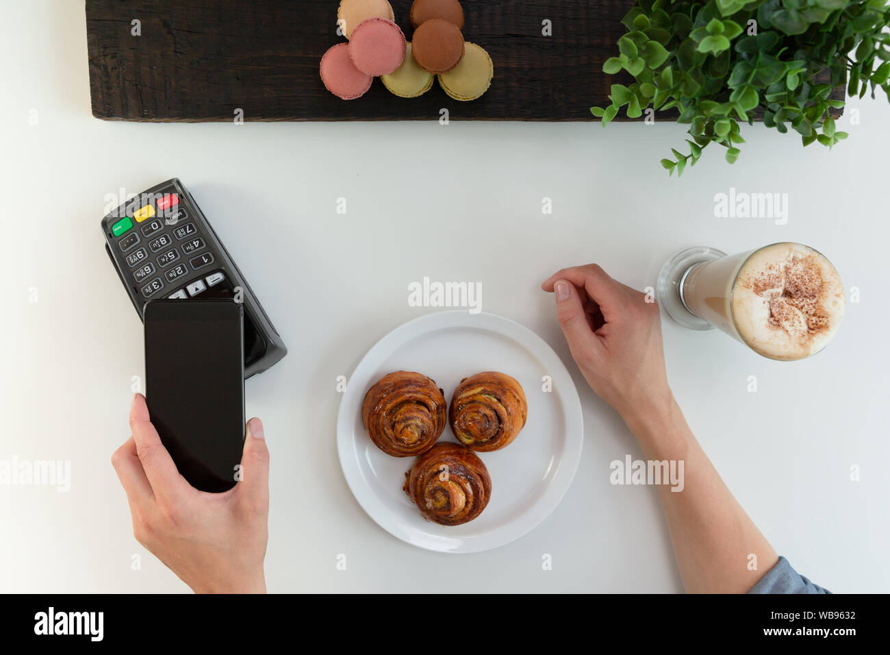 Customer making wireless or contactless payment using smartphone, nfc payment Stock Photo