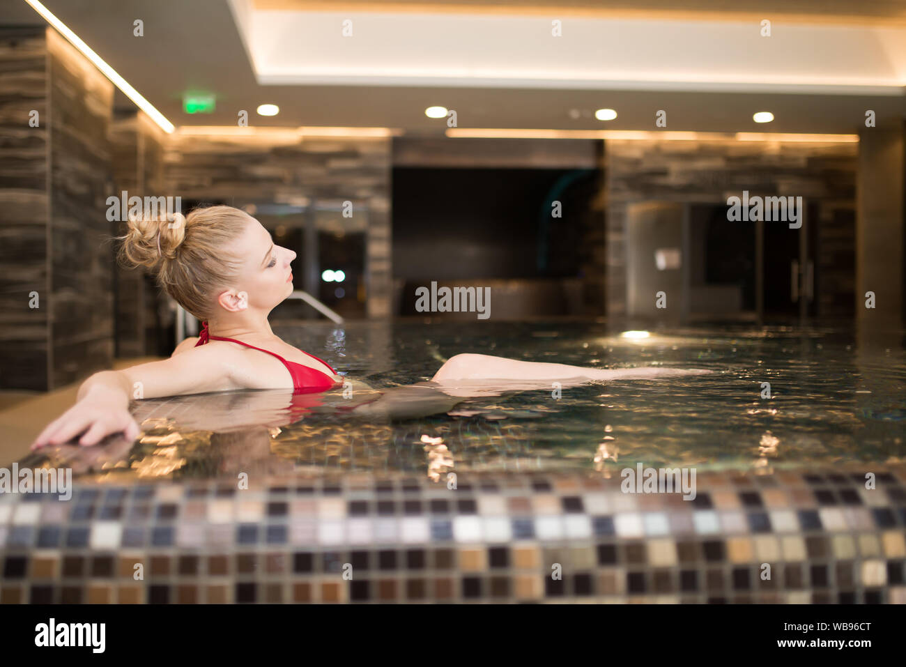 Woman relaxing in a pool Stock Photo - Alamy