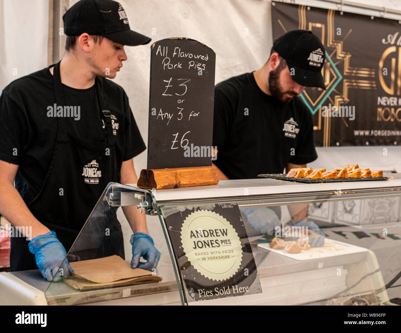 Employees at Yorkshire pork pie maker's Andrew Jones Pies stall, Harrogate Food and Drink Festival, Ripley, Harrogate, UK, 25 August 2019 Stock Photo